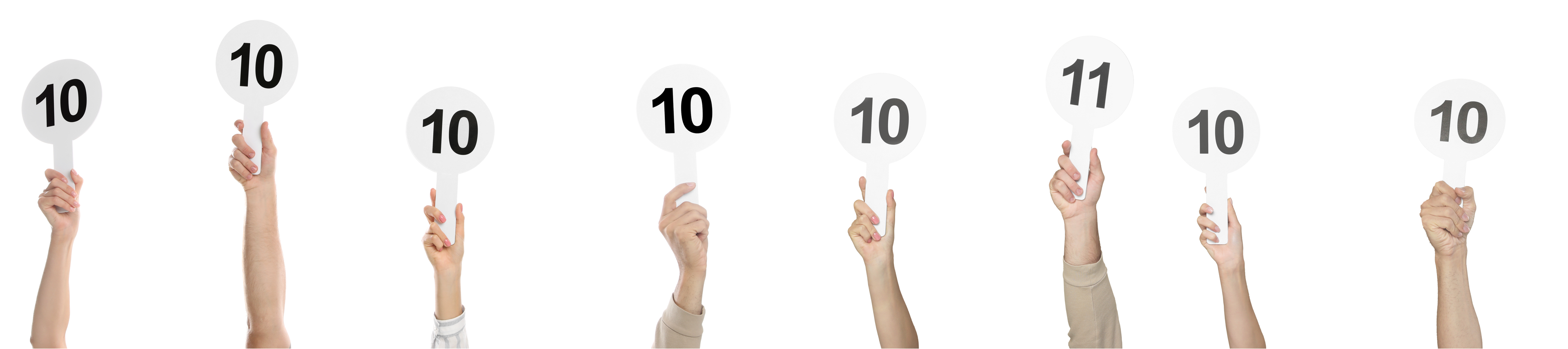 Eight hands held up in a row, each holding a scoring paddle; seven read 10 and one reads 11.